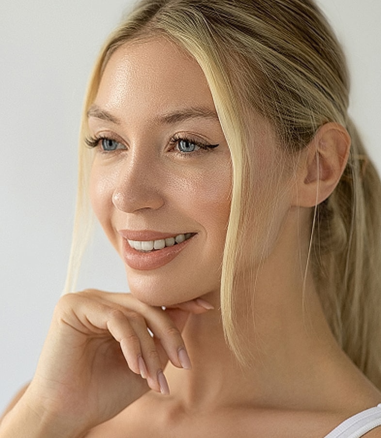 Smiling woman with blonde hair and blue eyes.