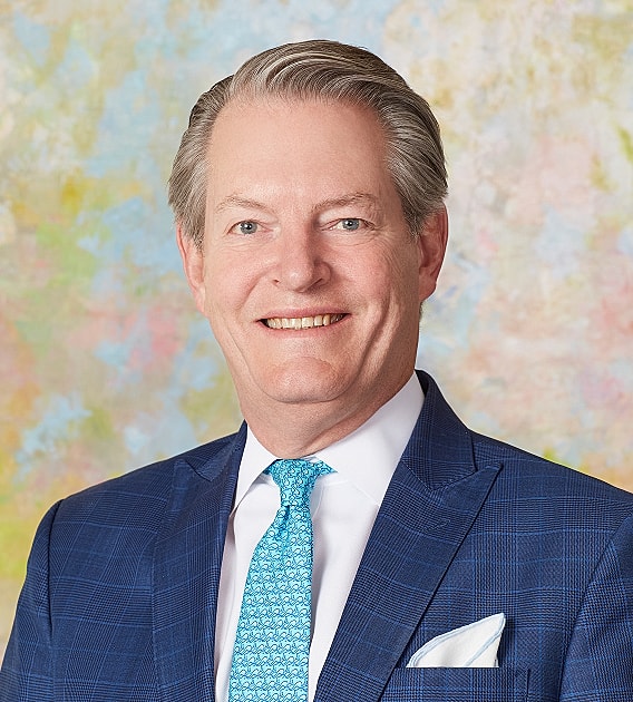 Smiling man in a blue suit with tie.
