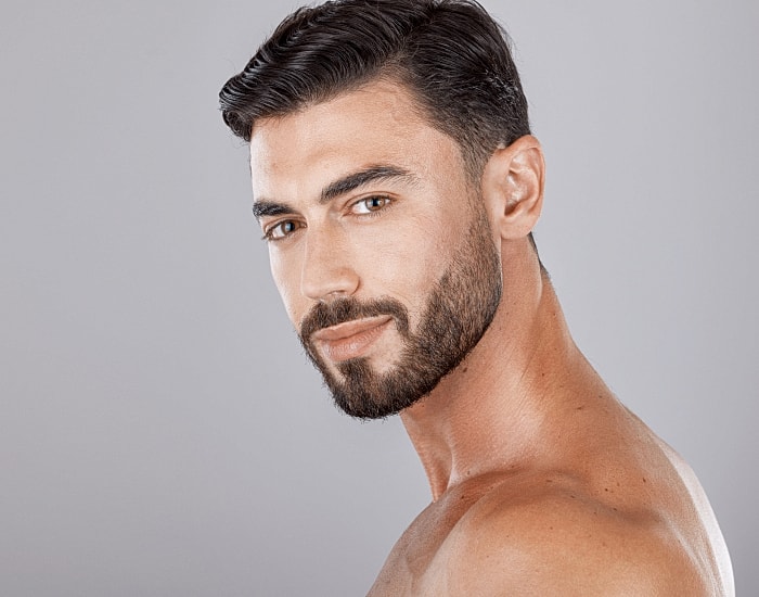 Young man with short hair and beard.